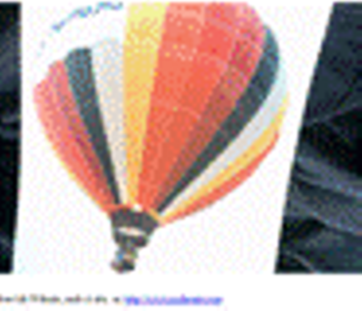 my-photo-of-a-hot-air-balloon-with-red-white-yellow-and-black--verticle-stripes--and-a-flame-shooting-up-inside-the-balloon-can-be-seen"